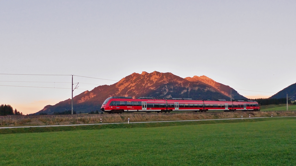 . Abendstimmung in Mittenwald - Vor unserem Feriendomizil Landhaus Wackerl, dem ersten Anwesen von Mittenwald, obwohl es ganz nah bei Klais liegt, hat man eine tolle Aussicht auf die Bahnstrecke 5504 M�nchen Hbf. - Mittenwald Grenze und so konnte ich die RB 5428 Seefeld in Tirol - M�nchen Hbf im letzten Licht des 04.10.2015 vor der Soierngruppe ablichten. (Jeanny)