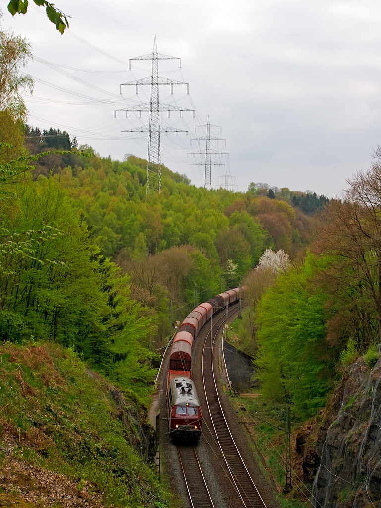 Bedingt durch Defekts und Hauptuntersuchungen an den eigenen MaK On Rail DH 1004 Loks der WEBA hat die Westerwaldbahn zurzeit die sch�ne altrote 215 086-0 (eigentlich 225 086-8) von der RE - Rheinische Eisenbahn angemietet. 

Hier bringt die V 163 am 10.04.2014 einen Coilg�terzug (leer) aus Selters/Ww via Altenkirchen und Au/Sieg nach Betzdorf/Sieg, sie �berquert gerade bei Scheuerfeld die Sieg, bevor es durch den 32 m langen M�hlburg-Tunnel geht. 

Die V 163 wurde 1971 bei MaK unter der Fabriknummer 2000091 und an die DB ausgeliefert, 2001 ging sie an die DB Cargo AG und wurde in 225 086-8 umbezeichnet, ob sie die Dampfheizung behaten hat kann ich nicht genau sagen. Mit der Ausmusterung bei der nunmehrigen DB Schenker Rail Deutschland AG im Jahr 2011 erfolgte auch der Verkauf an die RE - Rheinische Eisenbahn, hier wurde sie wieder in den Auslieferzustand zur�ckversetzt und tr�gt nun wieder die Bezeichnung 215 086-0 ist aber weiter einer 225er (NVR-Nummer 92 80 1225 086-8 D-EVG).