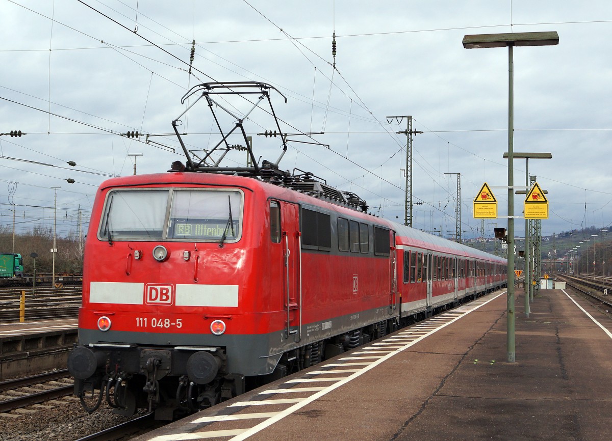 DB: Im Regionalverkehr Basel Badischer Bahnhof-Offenburg sind die DB Regio Altbaulokomotiven der BR 111 aus den Jahren 1975 bis 1984 nach wie vor unentbehrlich. 111 048-5 mit alten Wagen bei der Ausfahrt Weil am Rhein in Richtung Offenburg am 8. Januar 2015. Besonders zu beachten sind die verschiedenen Stromabnehmer der BR 111.
Foto: Walter Ruetsch 
