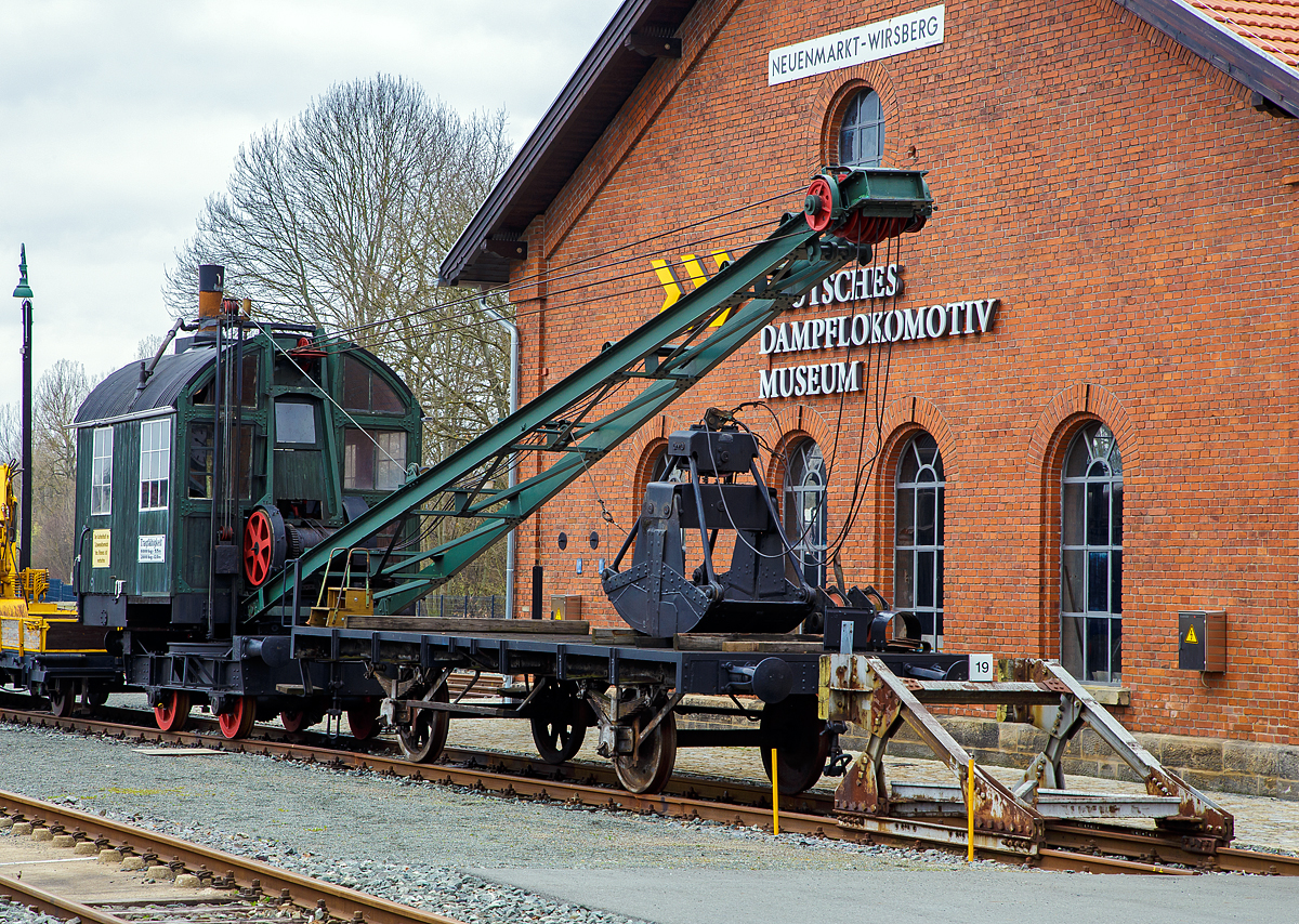 
Der DEMAG Dampfkran / -bagger mit einem zweiachsigen Schutzwagen am 26.03.2016 ausgestellt im Deutschen Dampflokomotiv-Museum DDM in Neuenmarkt-Wirsberg. 

Gebaut wurde der Dampfkran bzw. Dampf-Seilbagger 1927 von der  Demag AG in Duisburg unter der Fabriknummer 5363. Der derzeit nicht betriebsfähige Dampfdrehkran des DDM war bis 1973 im Hafen Deggendorf im Einsatz.

Der Schienenkran hat ein zweiachsiges angetriebenes Laufwerk, einen Drehkranz, neigbarem Ausleger und zwei Zugseilen (für Zweiseil-Greifer). Antrieb durch eine liegende Zwillingsdampfmaschine mit Gabelrahmen, gebohrten Kreuzkopfgleitbahnen. Die Joy-Steuerung mit je zwei schwenkbaren Gleitstücken je Zylinder ist über der Kurbelwelle. Die Welle treibt über Stirnräder und mit Klauenkupplungen ausrückbaren Kegelrädern die Seiltrommeln, das Fahr- und Drehwerk an. Der Kessel ist stehend mit einen max. Druck  8 bar leistet er max. 200 kg/h Dampf. Die Kesselspeisung erfolgt über 2 Injektoren, außerdem ist ein dritter Injektor vorhanden, mit dem bei Bedarf Wasser von außen in den Reservetank gesaugt werden kann.

Der Kran kann auch Rangieraufgaben bewältigen, seine Zugkraft reicht für 3 beladene Wagen (20t) oder 9-10 leere Wagen aus. Der Baggergreifer kann (bei einer Tragkraft 3 t) 1,5 m³ Kohle aufnehmen.

TECHNISCHE DATEN:
Hersteller:	DEMAG AG, Duisburg
Spurweite: 1.435 mm (Normalspur)
Bauart: Dampfkran B n2t
Länge über Kupplung: 4.920 mm
Dienstgewicht: ca. 28 t
Höchstgeschwindigkeit: 6,6 km/h
Tragkraft: 6.000 kg bei Auslage 5,5 m / 2.000 kg bei Auslage 12 m
Steuerungsbauart: einfacher Schieber, umsteuerbar
Zylinderzahl: 2
Dampfdruck: 8 bar
Leistung: 25 bis 30 PS
