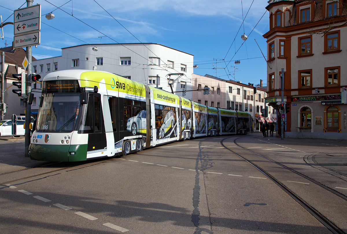 
Der Triebwagen 895 der swa (Stadtwerke Augsburg Verkehrs-GmbH), als Linie 2 (nach Augsburg West P+R), erreicht am 08.02.2020 die Station Augsburg Oberhausen  Bf / Helmut-Haller-Platz. 

Der Triebwagen ist ein CF8 CityFlex (siebenteiliger Niederflur-Gelenktriebwagen im Einrichtungsbetrieb vom Typ Bombardier Flexity Outlook C, ex Cityrunner).
Der modernste Straßenbahntyp Augsburgs sind die 27 in den Jahren 2009 und 2011 gelieferten Cityrunner von Bombardier Transportation, die vor Ort als CityFlex oder CF8 bezeichnet werden. Erstmals in der Geschichte der Augsburger Straßenbahn verfügt dieser Typ durchgehend über Klimaanlagen. Der CityFlex hat sechs doppelflügelige und zwei einflügelige Türen. Bis auf drei Wagen wurde die Option auf weitere Fahrzeuge eingelöst. Nach einer von technischen Defekten geprägten Inbetriebnahme Phase – unter anderem Türstörungen – befinden sich mittlerweile alle CF8 im Linienverkehr. Sie ersetzten die letzten Stuttgarter GT4 und alle GT8. Die CF8 verkehren auf allen Augsburger Straßenbahnlinien.

TECHNISCHE DATEN:
Spurweite: 1.000 mm
Achsfolge: Bo '2'Bo' Bo'
Gesamtlänge: 40.600 mm 	
Wagenkastenbreite : 2.300 mm
Sitzplätze: 85
Stehplätze: 143 (4 Pers/m²)
Netzspannung: 	750 V DC Oberleitung
Leistung: 6 x 105 kW
Höchstgeschwindigkeit: 70 km/h
Fußbodenhöhe: 320 mm 
Achsabstand im Drehgestell: 1.850 mm
Treib- und Laufraddurchmesser: 572 mm (neu) / 500 (abgenutzt)
Eigengewicht: 47.900 kg
Anzahl und Art der Fahrmotoren: 6 luftgekühlte Drehstrom Asynchronmotore 
Bremssysteme: 8 x 66 kN Magnetschienenbremse, regenerative elektrodynamische Bremse

Die Straßenbahn Augsburg bildet das Rückgrat des öffentlichen Nahverkehrs in Augsburg und ist das zweitgrößte Straßenbahnsystem Bayerns nach München und vor Nürnberg und Würzburg. Das meterspurige Netz ist 45,4 Kilometer lang und wird von fünf Linien bedient. Die 1881 eröffnete Straßenbahn befördert jährlich etwa 61 Millionen Fahrgäste und wird heute von den Stadtwerke Augsburg Verkehrs-GmbH (SWA) betrieben. An drei Stellen überquert sie die Stadtgrenze, so dass ein Teil des Netzes in den Nachbarstädten Friedberg und Stadtbergen liegt. Ergänzt wird das Straßenbahnnetz durch den 1927 aufgenommenen städtischen Omnibusverkehr, zwischen 1943 und 1959 verkehrte außerdem der Oberleitungsbus Augsburg in der Stadt.

Sehr positiv ist die Tatsache der kostenfreien City-Zone:
Im Stadtgebiet Augsburg sind alle Fahrten zwischen den Haltestellen Königsplatz, Hauptbahnhof, Frohsinnstraße, Theodor-Heuss-Platz/IHK, Ulrichsplatz, Moritzplatz, Rathausplatz, Staatstheather und Prinzregentenstraße kostenfrei.
Auch Tagesticket für den Augsburger Innenraum (Zone 10 und 20) sind mit 6,80 Euro recht günstig. Es gilt Wochentags ab 9 Uhr, an Feiertagen und am Wochenende ganztags. Man kann bis zu 4 Kinder kostenlos und bis zu 4 weitere Personen für je 2,20 Euro mitnehmen.
So kostete es meine Frau und mich 9 Euro und wir konnten Augsburg mit dem ÖPNV erkunden.
