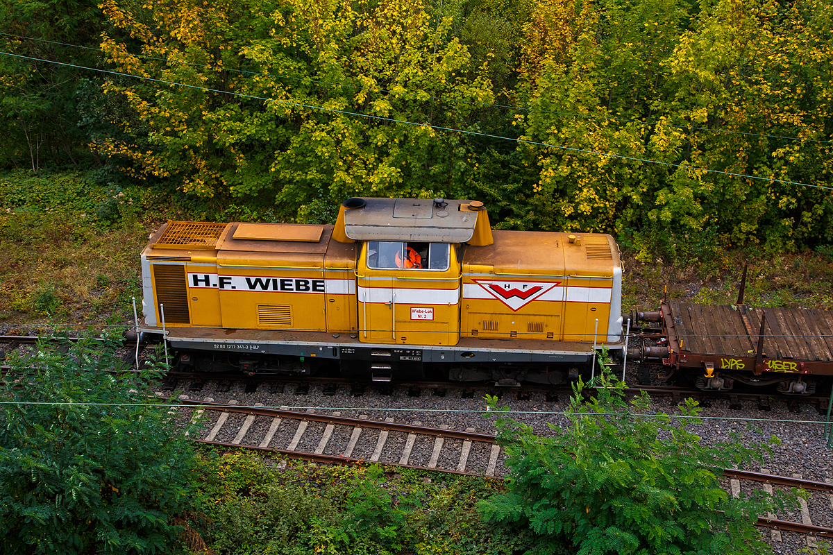 
Die Wiebe Lok 2 bzw. 211 341-3 (92 80 1211 341-3 D-BLP), ex DB 211 341-3, ex DB V 100 1341, drückt am 26.09.2020 einen Wagenzug in den Rbf Betzdorf (Sieg).

Die V 100.10 wurde 1962 von Arnold Jung Lokomotivfabrik GmbH, Jungenthal bei Kirchen an der Sieg, unter der Fabriknummer 13468 gebaut und als V 100 1341 an die Deutsche Bundesbahn geliefert. Zum 01.01.1968 erfolgte dann die Umzeichnung in DB 211 341-3, als diese fuhr sie bis zur Ausmusterung 1988. Im Jahr 1990 ging sie an die H. F. Wiebe KG, wo sie erst als Lok 1 geführt wurde.