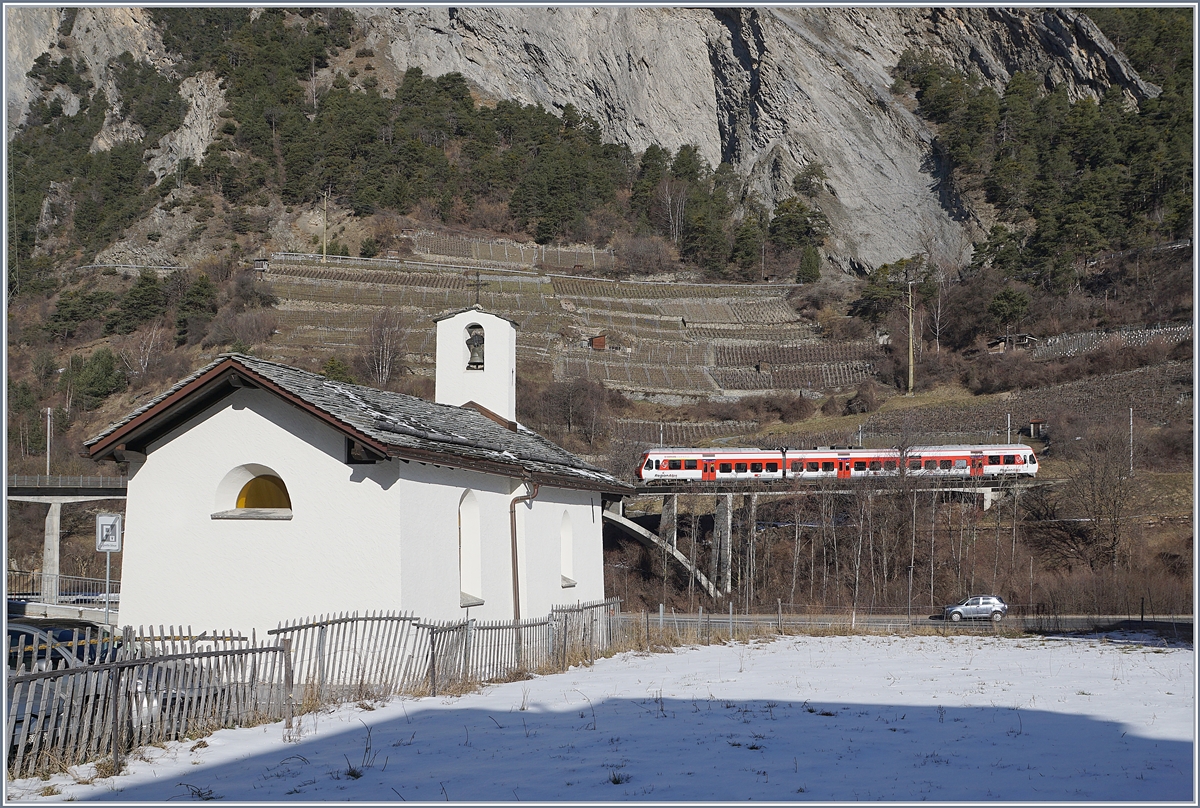 Im Vordergrund die aus dem Jahre 1445 stammende Chapelle des Sept Joies (die Sieben Freuden Marias) in Sembrancher und im Hintergrund ein RegionAlps RABe 525 als TMR Regionalzug 26118 auf dem Weg von Martigny nach Le Châble.

9. Februar 2020