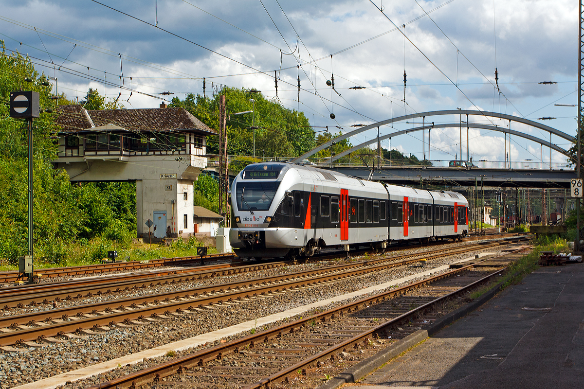 
In einem etwas neuen Outfit (rote Türen) und mit neuer Fahrzeugbezeichnung....  
Der ET 232104  Hagen , ex ET 23004 (94 80 0427 103-7 D-ABRN / 94 80 0827 103-3 D-ABRN / 94 80 0427 603-6 D-ABRN) der Abellio Rail NRW GmbH (ein 3-teiliger Stadler Flirt EMU 3bzw. BR 0427), als RE 16  Ruhr-Sieg-Express  (Siegen - Kreuztal - Finnentrop - Hagen - Essen), am 12.08.2014 kurz vor der Einfahrt in den Bahnhof Kreuztal.  Er fährt hier gerade man Reiter-Stellwerk Kreuztal Fahrdienstleiter (Kf) vorbei.

Zuvor hatte der FLIRT silberne Türen, nun mit den roten Türen gefällt er mir persönlich noch besser.