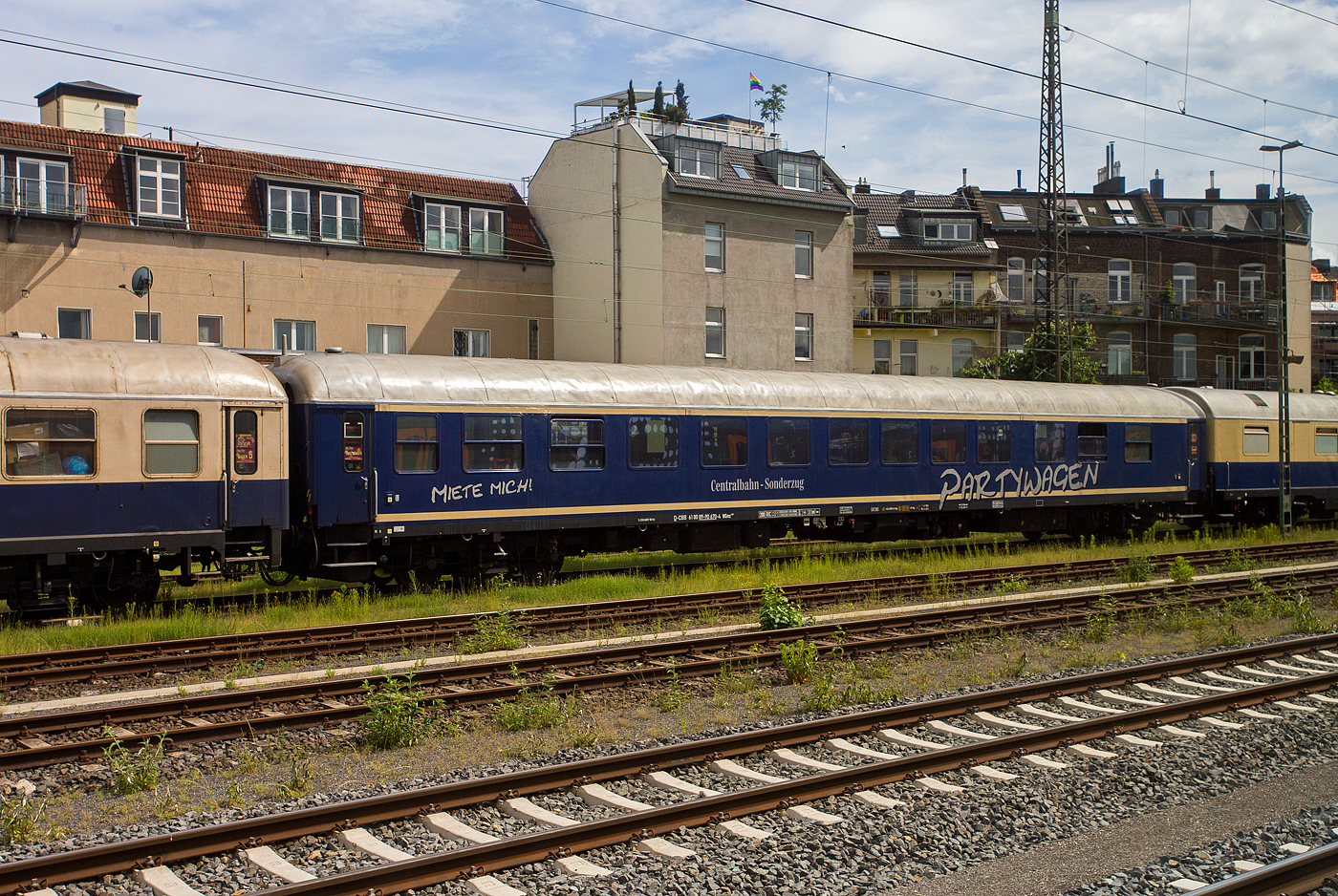 Der Gesellschaftswagen/Partywagen D-CBB 61 80 89-90 670-4 der Gattung WGmz 820 der Centralbahn GmbH (M�nchengladbach), eingereiht im Zugverband eines mit 12 Wagen sehr langen Sonder- oder Partyzug der CBB, am 16 Mai 2024 in K�ln-West, aufgenommen aus einen Zug heraus.

Der Wagen wurde 1964 von der Waggonfabrik Wegmann & Co. in Kassel als Halbspeisewagen BRbu4�m-61 gebaut und als 10 755 K�ln an die Deutschen Bundesbahn (DB) geliefert. 1966 wurde er zum Halbspeisewagen DB 51 80 85-40 059-7 BRbu�mh 282, 1978 wurde er durch Wegmann zum DB 51 80 89-40 751-5 WGm 840 umgebaut, im PFA Weiden (Partner f�r Fahrzeugausstattung GmbH) wurde er 1999 zum „BordClub“  D-DB 61 80 89-90 670-4 WGmz 820 umgebaut. Von der einstigen, fast 50 Wagen z�hlenden,  Gesellschaftswagenflotte  der Deutschen Bundesbahn sind unter der Regie der Bahn-AG gerade mal 6 Wagen (89-90 670 bis 675) in den BordClub WGmz 820 umgebaut worden. Im Januar 2003 bekam der 89-90 670 im Werk Neum�nster die aktuelle Fernverkehrslackierung als IC „Club“ Wagen, Mit Ausmusterung der letzten WGmz 820 am 31.12.2013, zu denen auch dieser geh�rte endete die �ra der Gesellschaftswagen bei der Deutschen Bahn AG! Allerdings konnten diese noch an die Centalbahn und BTE verkauft werden, dieser wurde zum 31.12.2013 an die Centralbahn verkauft.

Der Wagen ist f�r eine H�chstgeschwindigkeit von 200 km/h zugelassen
