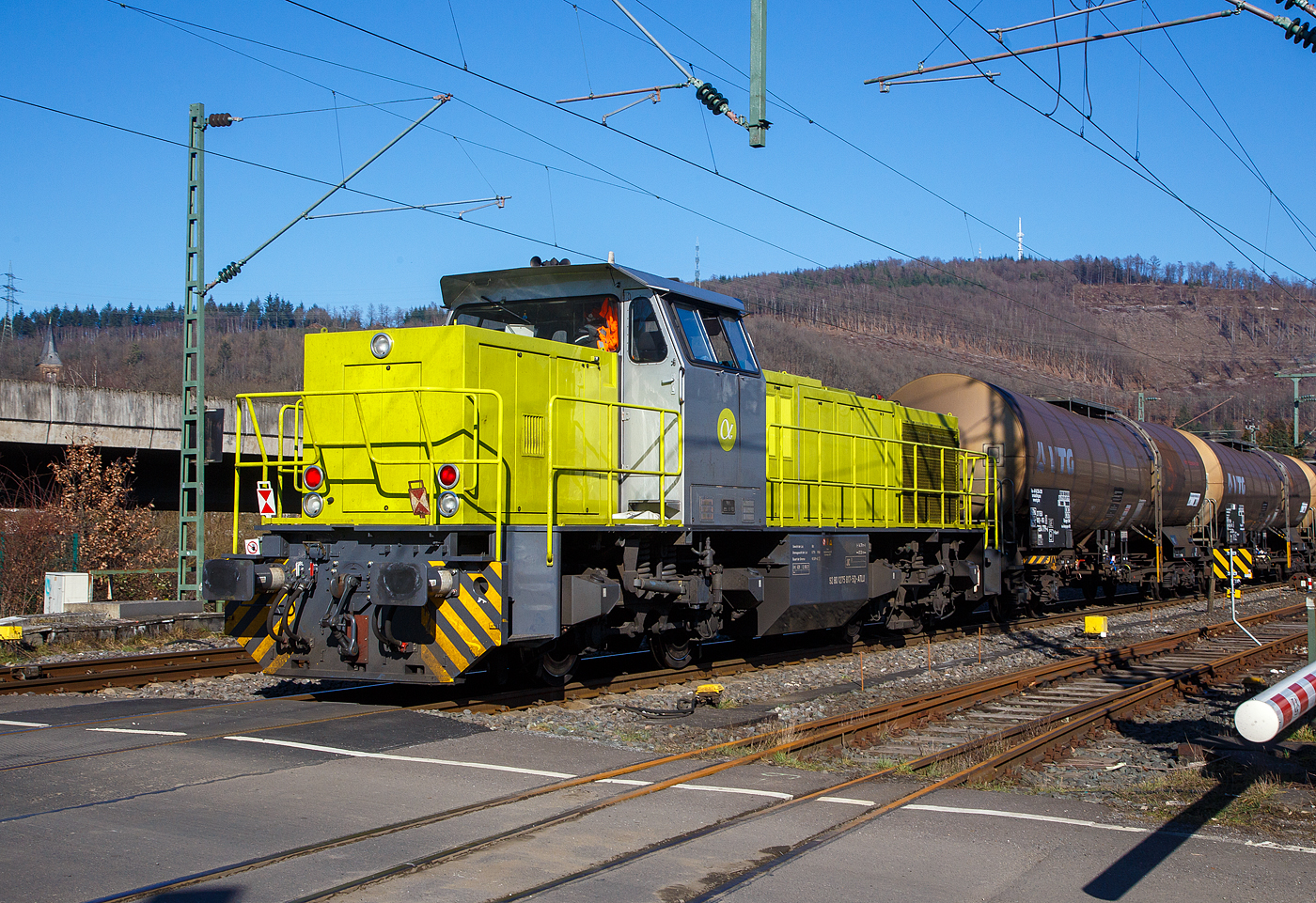 Die 275 817-5 (92 80 1275 817-5 D-ATLU) der Alpha Trains Belgium, am 14.02.2023 als Schlussläufer vom sogenannten  Henkelzug , beim Bü 343 (km 112,183) in Niederschelderhütte.

Die G 1206 wurde 2000 von Vossloh in Kiel unter der Fabriknummer 1001026 gebaut und war von 2000 bis 2006 an die RBH - RAG Bahn und Hafen GmbH bis Dezember 2015 vermietet und führ dort als RAG 829 bzw. RBH 829 (ab 2007 - 9 2 80 1275 817-5 D-RBH).
