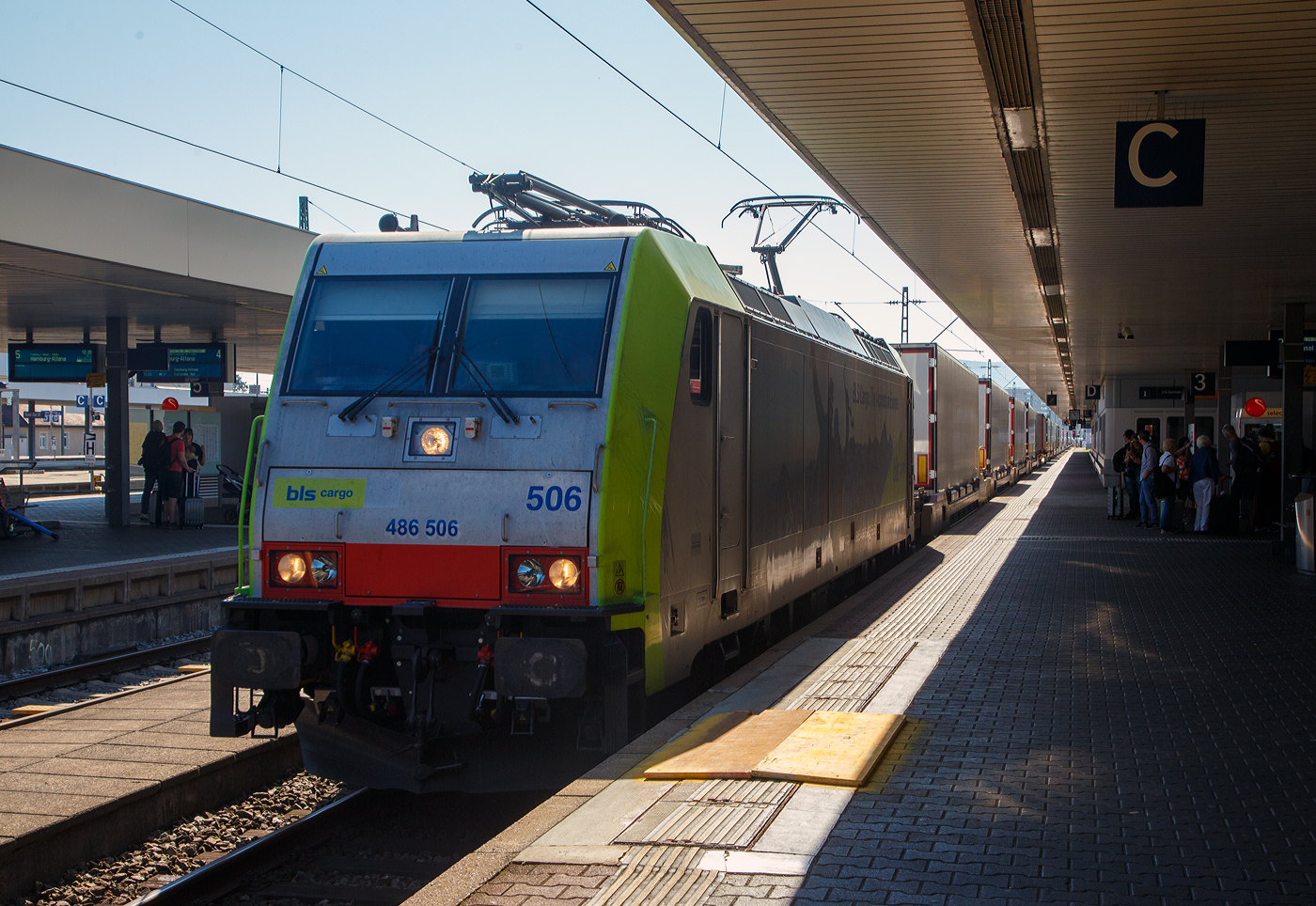 Die BLS Cargo 506, Re 486 506-9 (91 85 4486 506-9 CH-BLSC) f�hrt am 07 September 2023 mit einem KLV-Zug durch Basel Badischer Bahnhof im Richtung Weil am Rhein.

Die TRAXX F140 MS wurde 2008 von Bombardier in Kassel unter der Fabriknummer 34423 gebaut und an die BLS Cargo geliefert. Die Loks sind nur f�r die Schweiz, Deutschland, Italien und �sterreich zugelassen. 

Der Erfolg im G�terverkehr veranlasste die BLS zehn weitere TRAXX zu bestellen im Gegensatz zur ersten Serie TRAXX F140 AC1 mit der Bezeichnung Re 485 001 bis 485 020, die nur unter Wechselstrom fahren k�nnen, k�nnen die TRAXX F140 MS Re 486 501 bis 486 510 auch unter 3.000 Volt Gleichstrom eingesetzt werden. Bombardier hatte seit der ersten Lieferung Verbesserungen vorgenommen. Dabei wurde der Lokomotivkasten optimiert und die Traktionsausr�stung mit moderneren Komponenten versehen. Eine Nachbeschaffung w�re noch m�glich gewesen, h�tte aber dazu gef�hrt, dass die Lokomotiven nicht auf dem neuesten Stand waren und nicht unter der Gleichstromfahrleitung eingesetzt werden konnten. Die eingebauten Zugbeeinflussungssysteme erlauben den Einsatz in Deutschland, �sterreich, der Schweiz und Italien (DACHI). Anf�nglich waren die Lokomotiven in der Schweiz nur f�r den Einsatz auf Strecken mit konventioneller Zugbeinflussung und nicht auf ETCS Level 2-Strecken zugelassen. Die Re 486 k�nnen unter sich und mit den Re 485 und Lokomotiven der Baureihe 185/186 in Vielfachsteuerung eingesetzt werden.

TECHNISCHE DATEN:
Spurweite:  1.435 mm (Normalspur)
Achsformel:  Bo’Bo’
L�nge �ber Puffer:  18.900 mm
H�he:  4.385 mm
Breite:  2.978 mm
Drehzapfenabstand:  10.400 mm
Achsabstand im Drehgestell: 2.600 mm
Dienstmasse:  85 t
H�chstgeschwindigkeit:  140 km/h
Dauerleistung:  5.600 kW
Dauerzugkraft:  300 kN
Treibraddurchmesser:  1.250 mm
Stromsysteme:  15 kV 16,7 Hz, 25 kV 50 Hz Wechselstrom sowie 3 kV und 1,5 kV Gleichstrom
Antrieb:  Tatzlager
