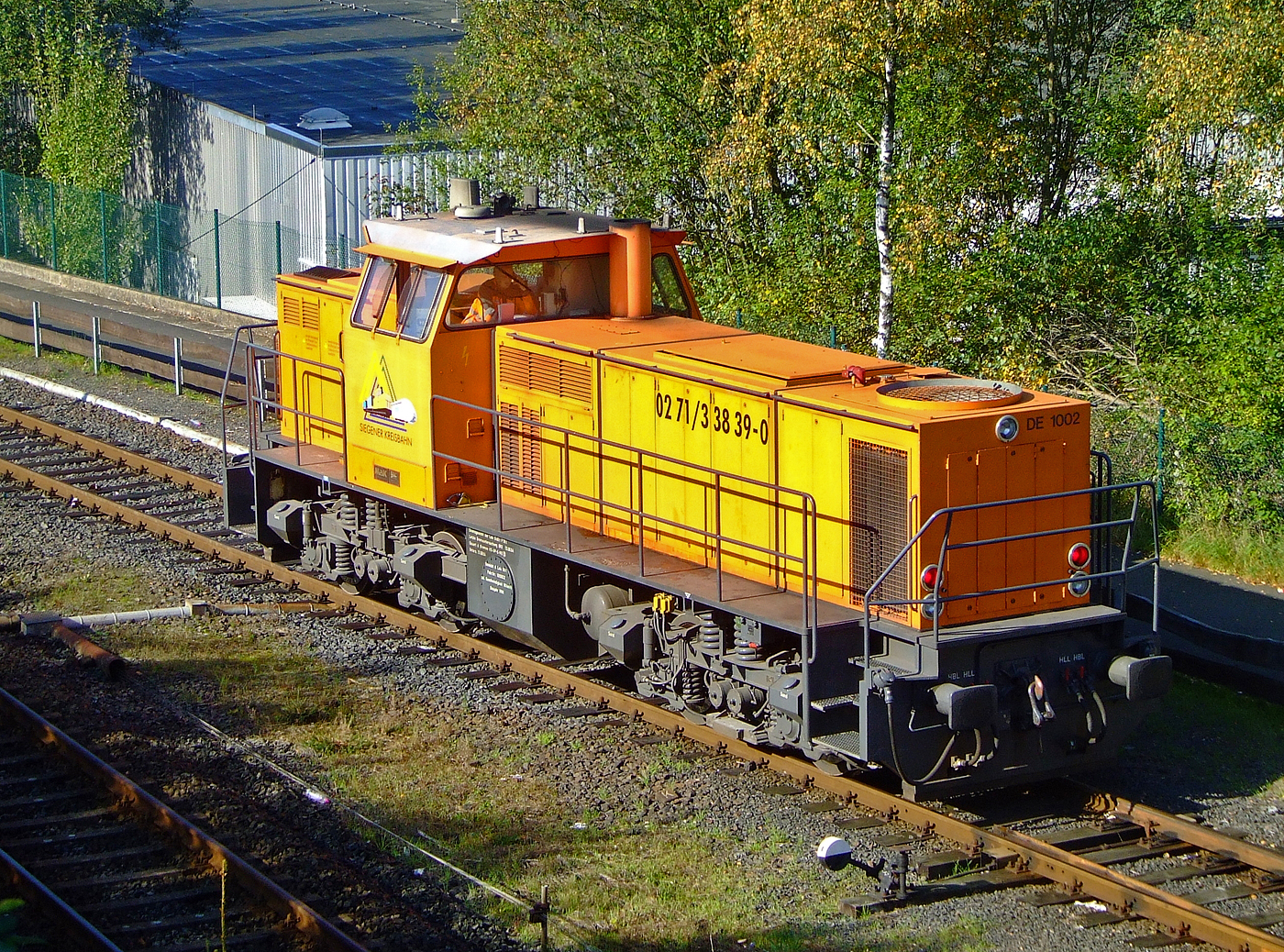Die KSW 41 bzw. 272 008-0 (98 80 0272 008-0 D-KSW) der Kreisbahn Siegen-Wittgenstein (KSW) am 06.10.2007 in Herdorf.

Die dieselelektrische DE 1002 wurde 1988 bei MaK unter der Fabriknummer 1000832 gebaut und an die HEG - Hersfelder Eisenbahn GmbH als 832 geliefert. Nach Einstellung des Bahnbetriebes der HEG ging sie konzernintern an die HLB - Hessische Landesbahn GmbH Lok 832 und 1996 wurde sie an die fr�here Siegener Kreisbahn GmbH als Lok 41 verkauft, die heute als Kreisbahn Siegen-Wittgenstein firmiert. Im Jahr 2017 wurde die Lok an NOBEG Reinold Eisenbahndienstleistungen (Furth im Wald) verkauft.

Gegen�ber den 16 Loks dieses Typs der HGK (mit MWM-Motor) hat diese Lok einen V 12-Zylinder-Dieselmotor mit Abgasturbolader und Ladek�hlung vom Typ MTU 12V396TC13 Dieselmotor mit 1.120 kW (1.523 PS) Leistung. Die Leistungs�bertragung erfolgt dieselelektrisch, das hei�t der Dieselmotor treibt einen Generator an der die 4 Drehstrom-Fahrmotoren mit Strom speist. Der Generator und die Fahrmotoren sind von BBC (heute ABB).

TECHNISCHE DATEN :
Spurweite: 1.435 mm
Achsfolge: Bo´Bo´
L�nge �ber Puffer: 13.000 mm
Drehzapfenabstand: 6.700 mm
Achsabstand im Drehgestell: 2.100
gr��te Breite: 3.100 mm
gr��te H�he �ber SOK: 4.220 mm
Raddurchmesser neu: 1.000 mm
kleinster befahrbarer Gleisbogen: 60 m
Dienstgewicht: 90 t
Motor: V-12-Zylinder-MTU-Dieselmotor vom Typ 12V396TC13
Motorleistung: 1.120 kW (1.523 PS)
Motornenndrehzahl: 1800 U/min
Kraftstoffvorrat: 2.900 l
H�chstgeschwindigkeit 75 km/h
