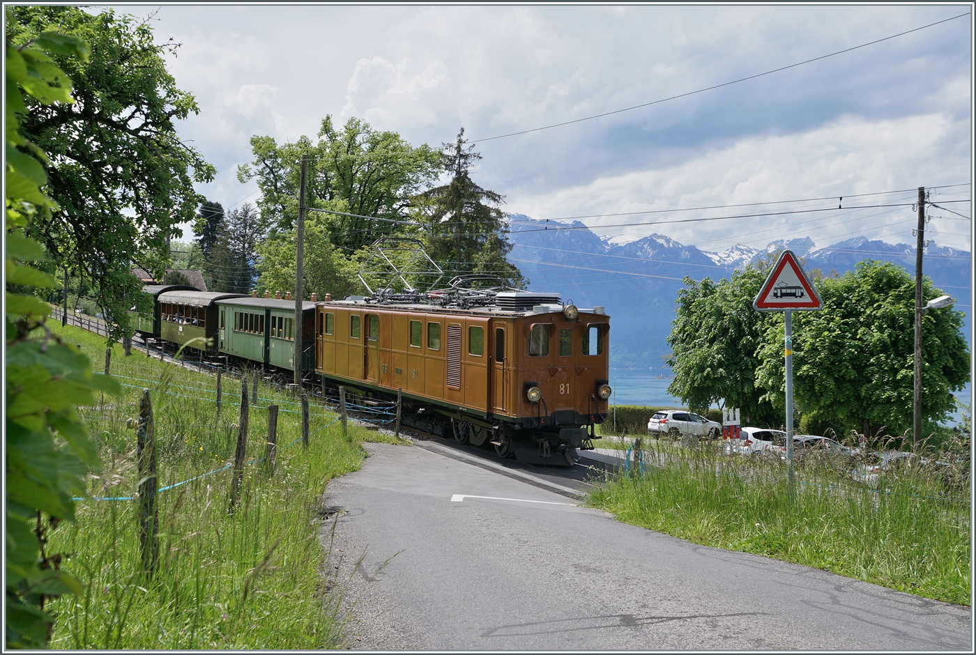 Festival Suisse de la vapeur 2024 / Schweizer Dampffestival 2024 der Blonay-Chamby Bahn - Bei Cornaux ist die Bernina Bahn RhB Ge 4/4 81 der Blonay Chamby Bahn mit ihrem bunten Zug auf der Fahrt nach Blonay.

20. Mai 2024