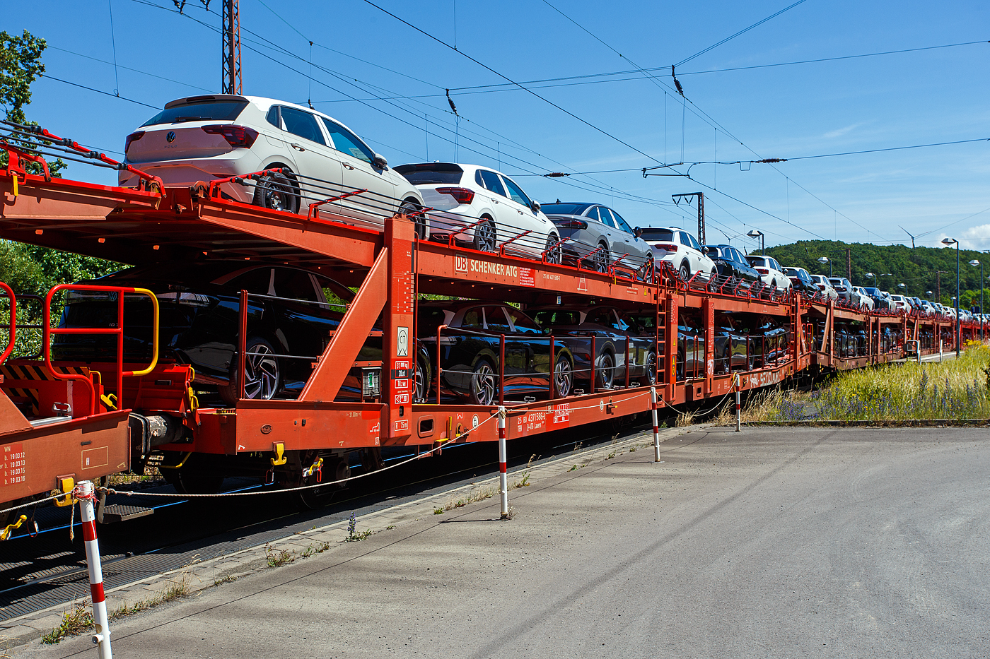Vierachsiger (2 x zweiachsiger) Doppelstock-Autotransportwagen der Gattung Laaers 560.1 (BA 5.854) der DB Cargo Logistics GmbH (ex DB Schenker ATG) eingestellt als 25 80 4371 586-2 D-ATG am 28 Juni 2024 im Zugverband bei der Zugdurchfahrt in Rudersdorf (Kreis Siegen).

Der Wagen wurde 2012 von der damaligen DB Waggonbau Niesky GmbH unter Fabriknummer 53982 gebaut.

Diese Waggons haben zwei Ladeebenen und sind f�r den europaweiten Transport geeignet. Sie werden f�r den internationalen Transport von PKWs, SUVs und Vans eingesetzt und bieten maximale Flexibilit�t durch eine stufenlos verstellbare obere Ladeebene. Aufgrund der hohen Lastgrenze (bis 34 t) ist der Transport von besonders schweren Fahrzeugen der genannten Typen m�glich.

Damit sowohl ein typenreiner Transport als auch eine Mischverladung in den unterschiedlichen Ladema�en m�glich ist, kann die obere Ladeebene hinsichtlich der Transportstellungen stufenlos eingestellt werden.

Durch die Entwicklung eines ver�nderten Ladungssicherungssystems wurde den Kundenanforderungen nach optimierten Transportm�glichkeiten f�r Fahrzeuge mit niedrigerer Bodenfreiheit Rechnung getragen.

TECHNISCHE DATEN:
Gattung: Laaers (Bauart 560.1)
Erstes Baujahr der Wagengattung: 2007
Spurweite: 1.435 mm
Anzahl der Achsen: 4 (2 x 2)
L�nge �ber Puffer : 31.000 mm
Achsabst�nde: 10.000 mm / 5.160 mm / 10.000 mm
Laufraddurchmesser (neu): �u�ere 840 mm und mittlere 730 mm
Ladel�nge : 30.070 mm (unten) / 30.550 mm (oben)
Ladel�nge waagerechter Teil untere Ebene: 19.400 mm
Ladebreite : 2.950 (unten) / 2.750 mm (oben)
H�chstgeschwindigkeit: 100 km/h (120 km/h leer)
Eigengewicht: 31.000 kg
Max. Zuladung bei Lastgrenze S: 33,0 t (ab Streckenklasse B, bei A 29,0 t)
Max. Zuladung der Ladeebenen: unten und oben jeweils max. 18 t
Max. Gewicht je Pkw: 2.800 kg (Radlast max. 1 t)
Anzahl der Radvorleger: 64
H�he Gel�nder oben: 600 mm
Kleinster befahrb. Gleisbogenhalbmesser: 75 m
Bremse: KE-GP-A (K)
Bremssohle: Jurid 816 M
Handbremse: Ja
Intern. Verwendungsf�higkeit: TEN-GE