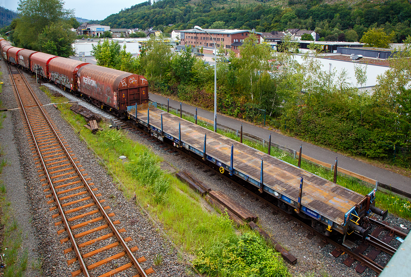 Vierachsiger Drehgestell-Flachwagen, mit Drehrungen mit  Stirnwandklappen, jedoch ohne Seitenwandklappen, 37 80 3915 405-9 D-WASCO, der Gattung Rs, der WASCOSA AG, am 24.08.2023 in Herdorf, im Zugverband eines Übergabezuges der KSW.